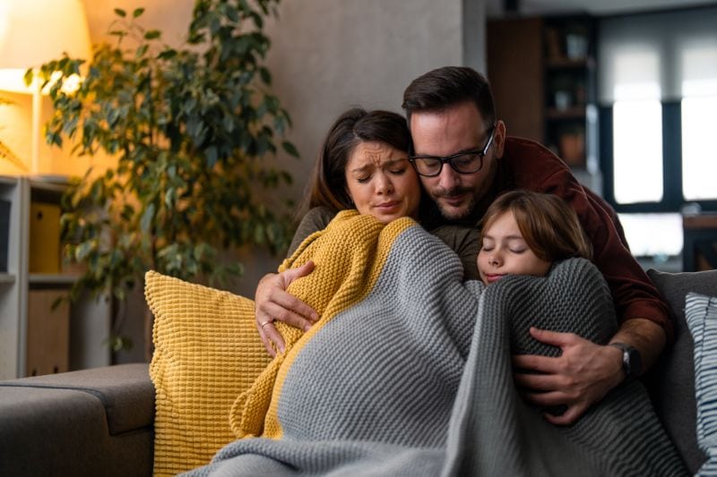 How Can I Make My Furnace Last Longer? - Family Wrapped up in a Blanket.